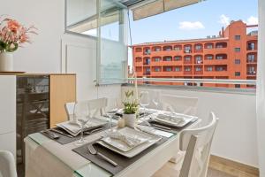 a dining room with a table and a large window at Miramar el Lago in Fuengirola