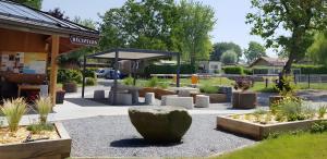 a garden with white sculptures in front of a building at Chalet 35m2 3 chambres in Sciez +4 photos