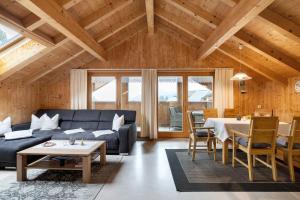 a living room with a couch and a table at Haus Vögel in Sibratsgfäll