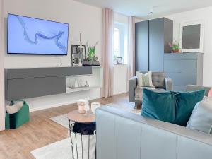 a living room with a couch and a tv at Schwarzwald Top Apartment in Lenzkirch