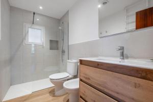 a bathroom with a toilet and a sink and a shower at Casa Con Vistas Aiguablava in Tamariu