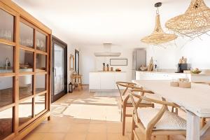 a kitchen and dining room with a table and chairs at Mallorquin Oasis, In Port Andratx in Andratx