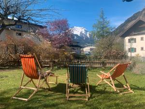 two chairs sitting in the grass in a yard at Ferienwohnung Durst 2 in Mayrhofen