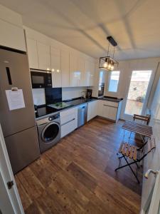 a kitchen with white cabinets and a washer and dryer at Las Natillas Con V - Martín Miguel in Martín Miguel +33 photos