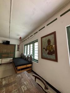 a living room with a bed and a table at Backpackers in Matara +16 photos