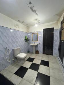 a bathroom with a toilet and a sink at Backpackers in Matara