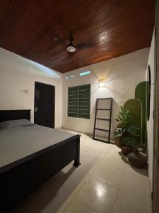 a bedroom with a bed and a wooden ceiling at Backpackers in Matara