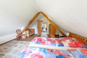 a bedroom with a bed in a attic at Ferienwohnung Jolly Joker in Freiamt