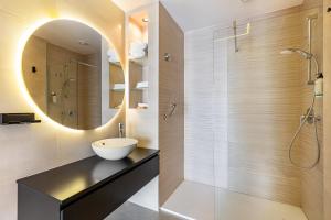 a bathroom with a sink and a mirror at La Pergola Apartament near Verona in Dossobuono +13 photos