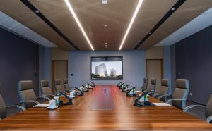 a conference room with chairs and a projection screen at Jianguo Hotel HUANQIU in Beijing