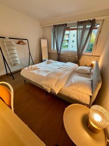 una camera da letto con un letto grande e una finestra di Basic & Simple on Langgrütstrasse a Zurigo