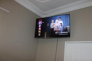 a flat screen tv hanging on a wall at Chic Guest House Alberton in Alberton
