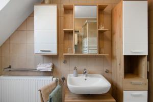 a bathroom with a sink and a mirror at Ferienwohnung Goesmann in Zetel +20 photos