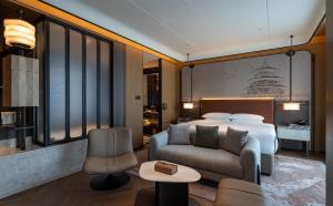 a hotel room with a bed and a chair at Jianguo Hotel HUANQIU in Beijing +34 photos