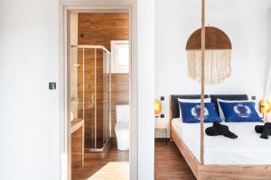 a bedroom with a swing bed and a bathroom at Mont' Rock villas 1 in Posidhonía +23 photos