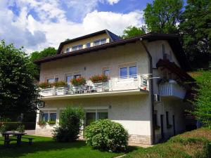a building with flowers on the balconies of it at Apartment Kanalec in Tolmin