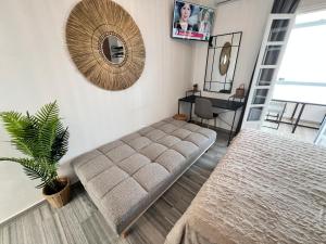 a living room with a couch and a desk at aeolian blu 3 in Parikia