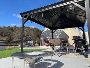awning over a table and a grill with a tent at Glamping x Kominka MASAZUMI Tei -and- GLAMPING&BBQ VILLAGE Takibi Terrace - Vacation STAY 97095v in Kawabe