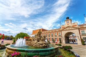 a fountain in front of a building with a clock tower at Tabist Station Hotel Isobe Ise-Shima in Shima