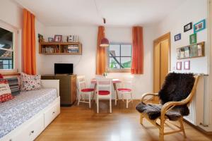 a bedroom with a bed and a table and chairs at Hofgut Uhenfels in Seeburg