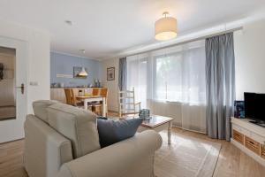 a living room with a couch and a tv and a table at Ferienwohnungen Zur Mühle in Sankt Michaelisdonn