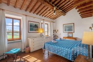 a bedroom with a bed and a desk and a window at Agriturismo Molinuzzo - Lisa in San Donato in Poggio