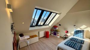 a small attic bedroom with a bed and a window at 2 - Seigneurie Fouquet - Chipagan in Le Palais