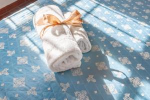 a towel with an orange bow on a bed at Agriturismo Molinuzzo - Joshua in San Donato in Poggio +22 photos