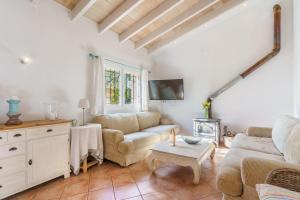 a living room with a couch and a table at Ca Ses Nines in Port d’Andratx