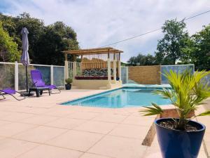 a swimming pool with a gazebo and a gazebo at Studio Romance dans la nature in Carnoules +16 photos