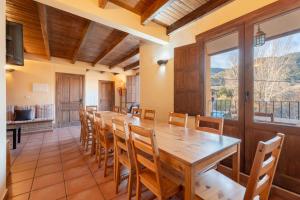 ein großes Esszimmer mit einem großen Holztisch und Stühlen in der Unterkunft La Posada in Chera