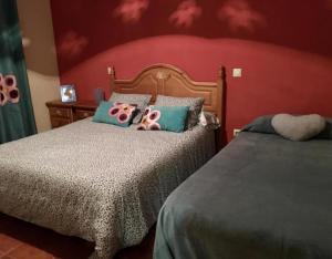 a bedroom with two beds with pink flamingos pillows at La Casita de Colmenar in Villaconejos +12 photos