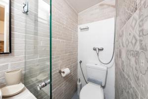 a bathroom with a toilet and a glass shower at Purity Studio in Anemómylos +17 photos