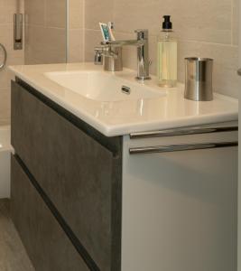 a bathroom with a sink with a soap dispenser on it at BnB San Giacomo in Ferrara +45 photos