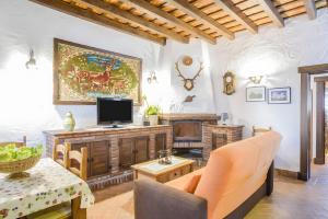 a living room with a tv and a couch at Cartuja Rural in Barbate