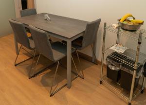 a dining room table with chairs and a bowl of bananas at BnB San Giacomo in Ferrara
