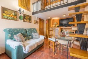 a living room with a couch and a table at Tomillo in Hinojares