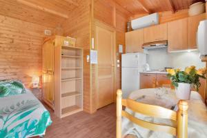 a small kitchen with a small table in a room at Joli Chalet en bois in Roquebrune-sur-Argens +16 photos