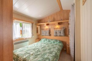 a bedroom with a bed in a small room at Mobil Home 6p - Près de la mer in Sémussac