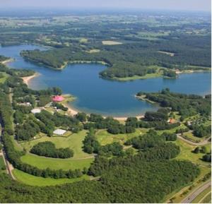 an aerial view of a lake with trees and a field at Het Haantje in Wilp