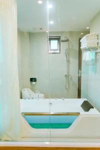 a bathroom with a shower and a bath tub at Sky Hotel in Ninh Binh