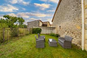 eine Gruppe von Stühlen in einem Hof neben einem Gebäude in der Unterkunft Gite de Lamour in Les Salles-de-Castillon + 13 Fotos