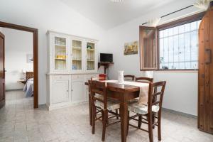 a dining room with a table and chairs at Casa Su Barone 2 in Orosei