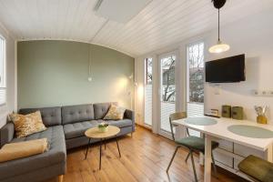 a living room with a couch and a table at Tiny House im Grünen in Jesberg