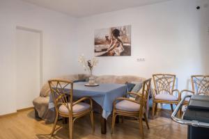 a dining room with a blue table and chairs at Ferienhaus Weingut Plonerhof in Bolzano +14 photos