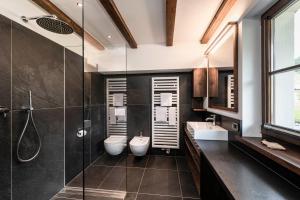 a bathroom with two toilets and a shower at Residence Cesa Rives in Selva di Val Gardena +101 photos