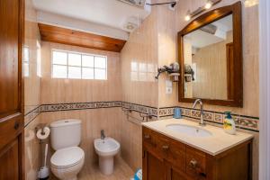 a bathroom with a toilet and a sink and a mirror at Eliasneil in Andratx +29 photos