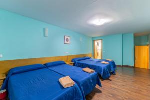 three blue beds in a room with blue walls at El Calderillo in Burgohondo +31 photos