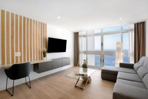 a living room with a couch and a tv at Luxury Loft Mar y Sol 1 in Tacoronte