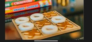 a tray of donuts and cookies on a table with books at Aqua Aura Pereybere in Grand Baie